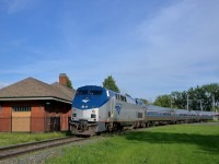 <b>Amtrak past an ex-Grand Trunk station.</b> The northbound <i>Adirondack</i> sweeps around the curve in front of the old Grand Trunk station in St-Jean-sur-Richelieu.