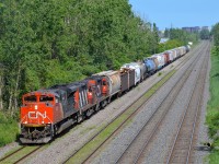 <b>Three GMD's on CN 527.</b> CN 527 has an SD70M-2 leading a pair of GP9's (CN 8935, CN 4140 & CN 7224) as it heads west towards Taschereau Yard on the transfer track.