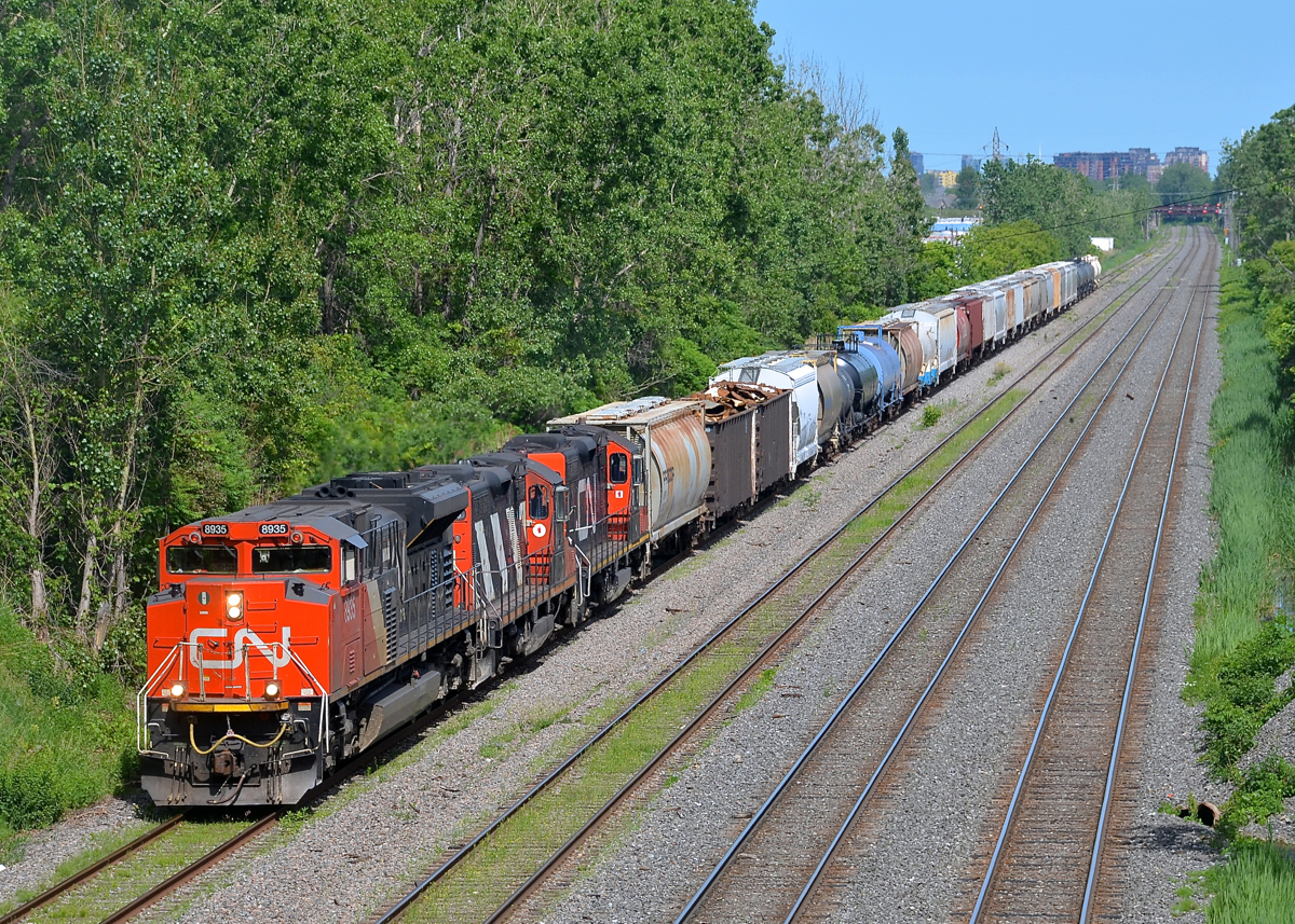 Three GMD's on CN 527. CN 527 has an SD70M-2 leading a pair of GP9's (CN 8935, CN 4140 & CN 7224) as it heads west towards Taschereau Yard on the transfer track.