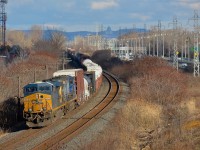 <b>A new angle.</b> A number of trees were just cut where CN's Kingston sub curves in Beaconsfield, opening up a new angle. Here CN 327 rounds the curve with CSXT 5419 & CSXT 310 just as the sun cooperates at the right time.