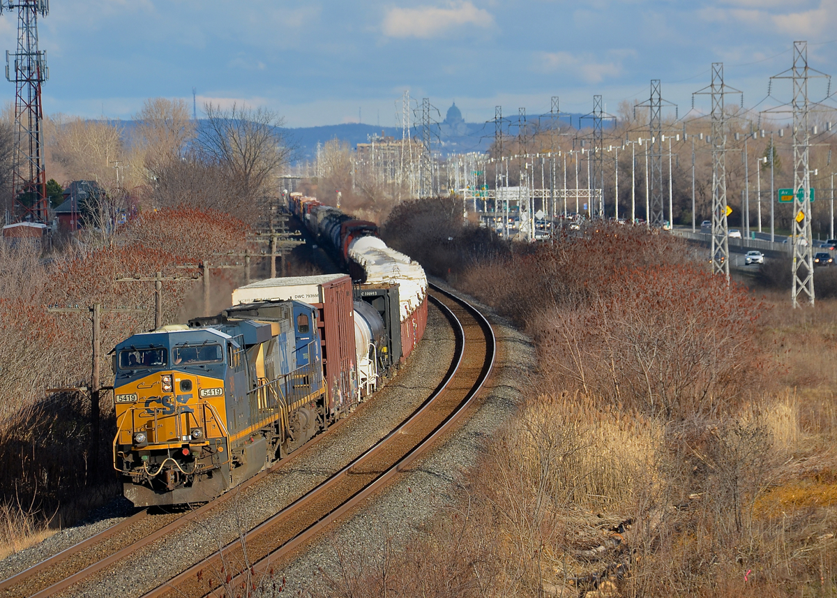 A new angle. A number of trees were just cut where CN's Kingston sub curves in Beaconsfield, opening up a new angle. Here CN 327 rounds the curve with CSXT 5419 & CSXT 310 just as the sun cooperates at the right time.