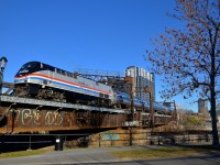 <b>A heritage unit, back in town.</b> For the second time in three days, AMTK 822 is on the southbound Adirondack out of Montreal. Here it backs up to Central Station before boarding passengers, as it crosses the Lachine canal.