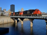 <b>A rare leader these days.... and unwanted by the crew.</b> Most of CN's ex-Oakway SD60's are in storage, so I was very surprised to see one leading CN 149 this morning. Apparently the crew was none too pleased as they ended up wyeing the power at Belleville. Here CN 5437 leads two more EMD's (SD75I's CN 5747 & CN 5666) as CN 149 crosses the Lachine canal on a gorgeous morning.