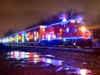 <b>Holiday train in the rain.</b> On what turned out to be a very rainy night unfortunately, the 2015 U.S. edition of the CP holiday train is making its stop at Delson, Qc with CP 2246 leading. It will make two more stops in Quebec before deadheading to New York.