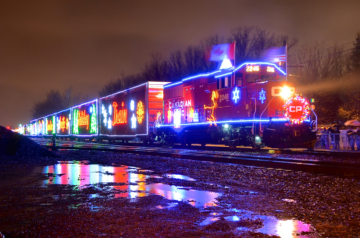 Holiday train in the rain. On what turned out to be a very rainy night unfortunately, the 2015 U.S. edition of the CP holiday train is making its stop at Delson, Qc with CP 2246 leading. It will make two more stops in Quebec before deadheading to New York.