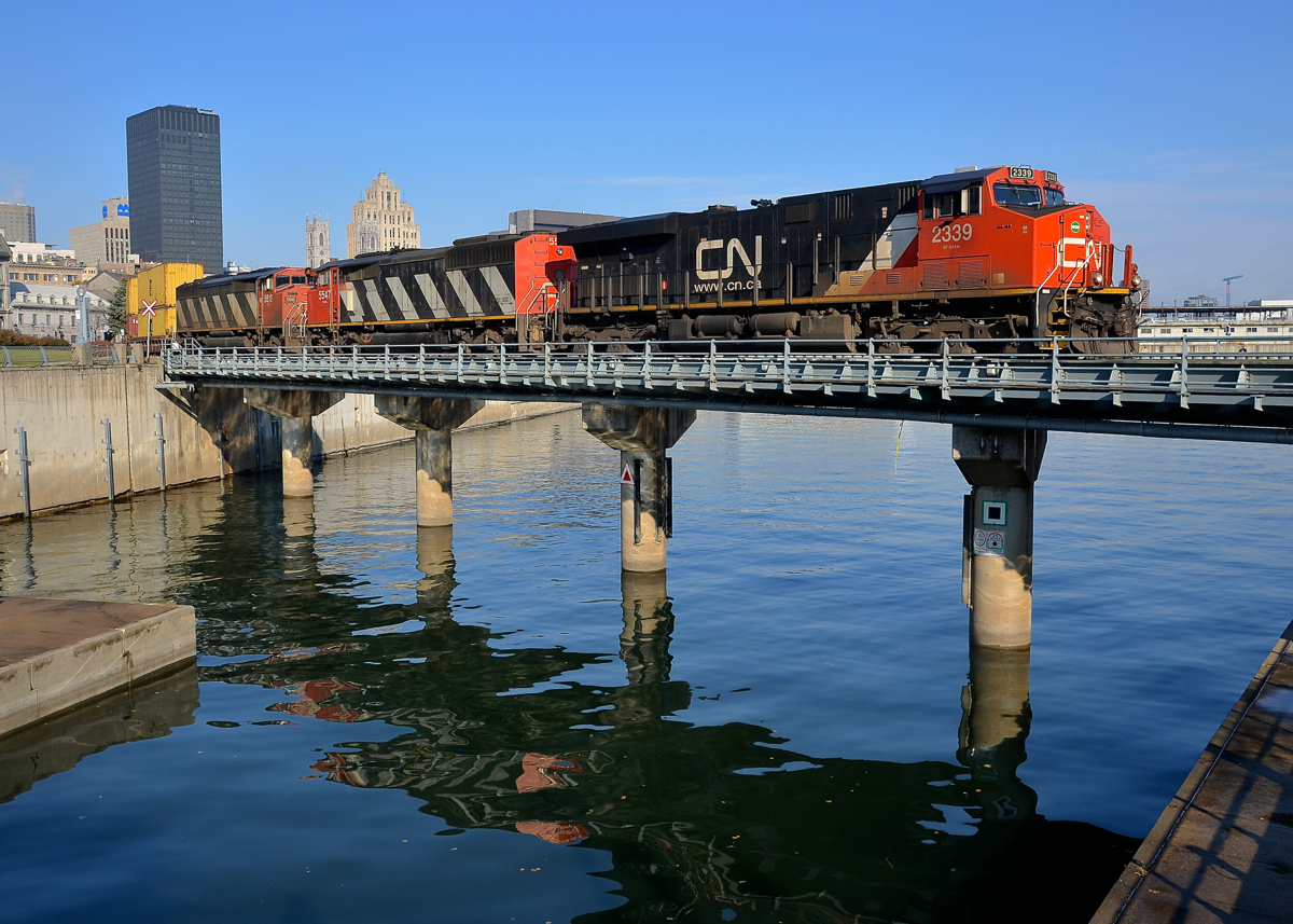 Not quite what I was hoping for. CN 148 was reported as having an ES44DC bracketed by a pair of SD60F's yesterday, which meant that an SD60F would most likely lead CN 149 out of the Port of Montreal the next morning. Unfortunately fume issues with the leader meant that the crew rearranged the lashup to have ES44DC CN 2339 leading. Here CN 149 crosses the Lachine Canal not too long after leaving the Port of Montreal, with a long intermodal train bound for Chicago. Power is CN 2339 with SD60F's CN 5547 & CN 5510 relegated to trailing status.