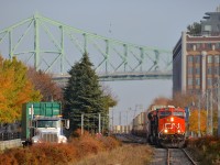 <b>Leaving Port of Montreal trackage.</b> After getting the okay from Port of Montreal security (as they have to flag the many crossing in this area), CN 149 is starting to pull with CN 2943 and CN 3023 for power as it leaves Port of Montreal trackage and enters the CN Wharf Spur. In the distance is the Jacques-Cartier bridge.