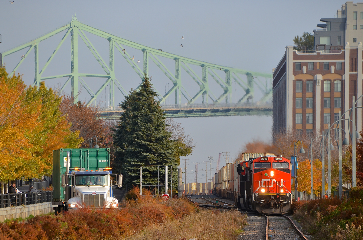 Leaving Port of Montreal trackage. After getting the okay from Port of Montreal security (as they have to flag the many crossing in this area), CN 149 is starting to pull with CN 2943 and CN 3023 for power as it leaves Port of Montreal trackage and enters the CN Wharf Spur. In the distance is the Jacques-Cartier bridge.