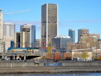 <b>Downtown Montreal in the background.</b> VIA 908 & VIA 6411 back VIA 63 up before its departure, with the skyline of downtown Montreal in the background. 