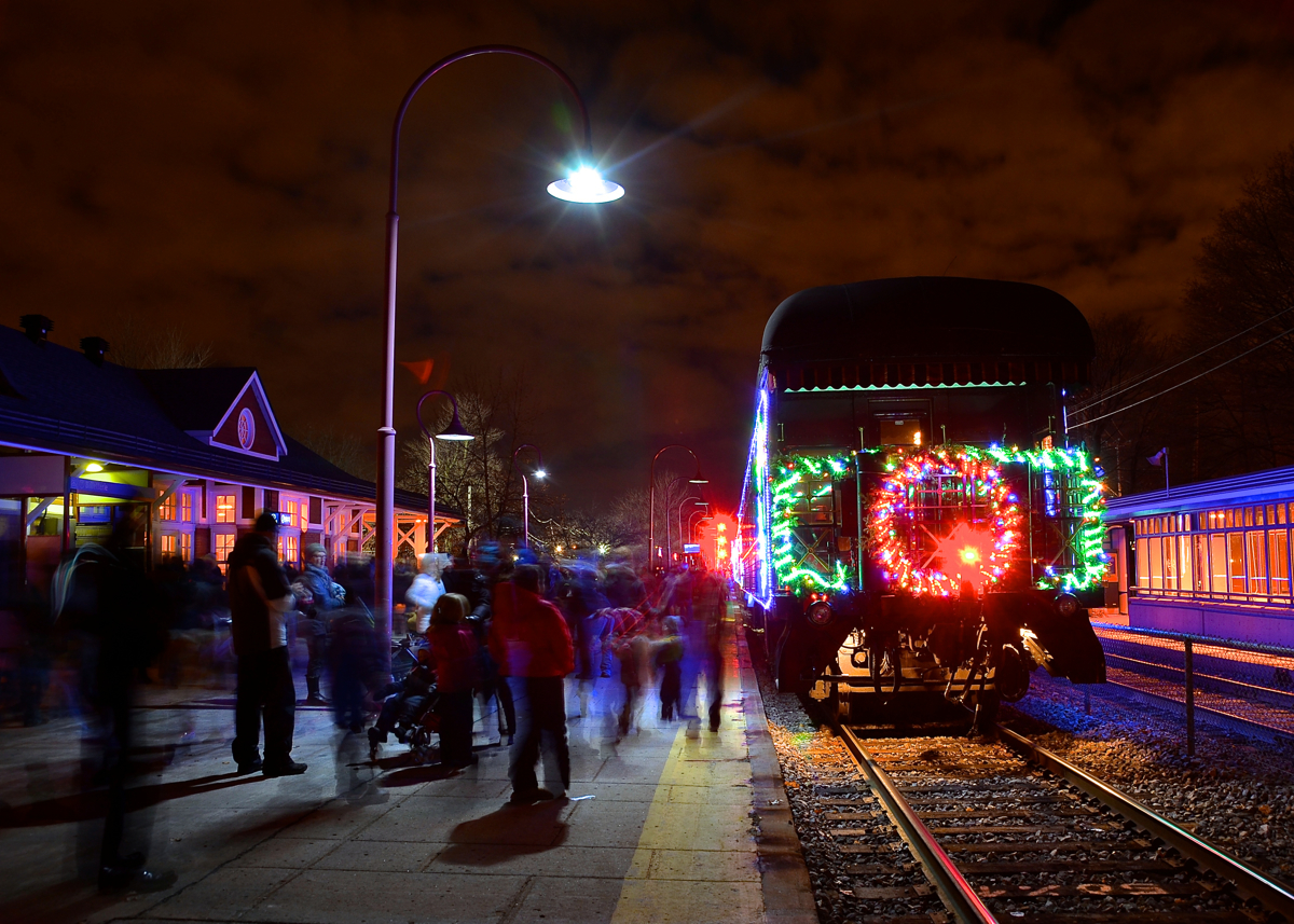 Tail end of the holiday train. The tail end of the Canadian edition of the CP Holiday Train is stopped in front of the venerable Montreal West station as the train makes its first stop of the year before continuing west towards its next stop at Beaconsfield. Bringing up the rear is the heavyweight car Van Horne, built by CP in 1927.