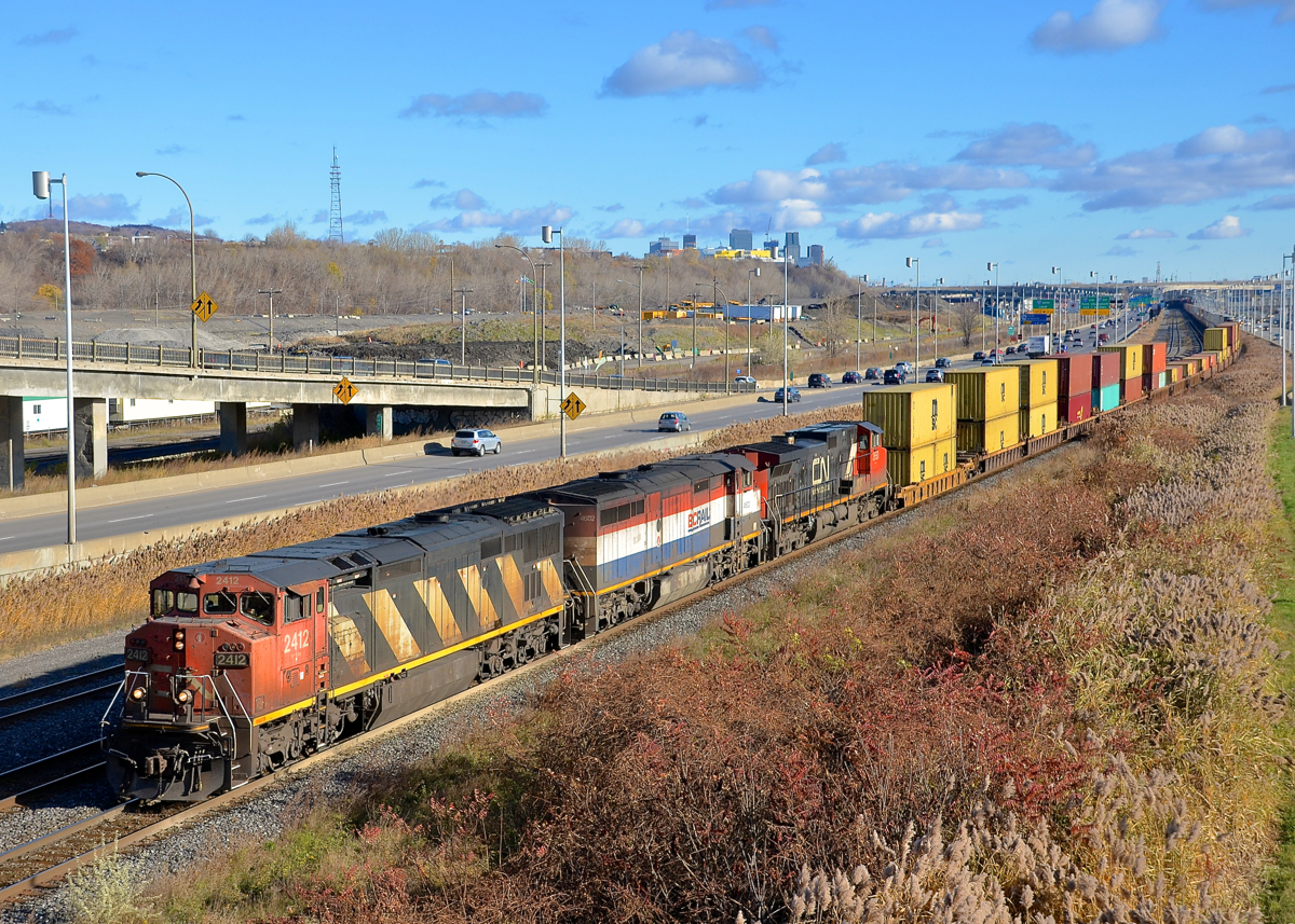 CN 149 has a pair of Dash8 cowls leading a Dash9 (CN 2412, BCOL 4062 & CN 2650) as it approaches the Angrignon overpass.