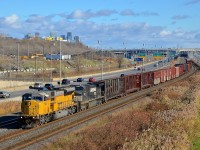 NS 7272, an ex-UP SD9043MAC, is leading CN 529 in Montreal as it approaches the Angrignon overpass. Trailing is NS 9710.