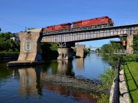 <b>CP 550 over an old swing bridge.</b> A pair of ES44AC's (CP 8878 & CP 8776) lead oil train CP 550 over the Lachine canal with a new crew onboard. This was once a swing bridge over the Lachine canal but is now locked in place.