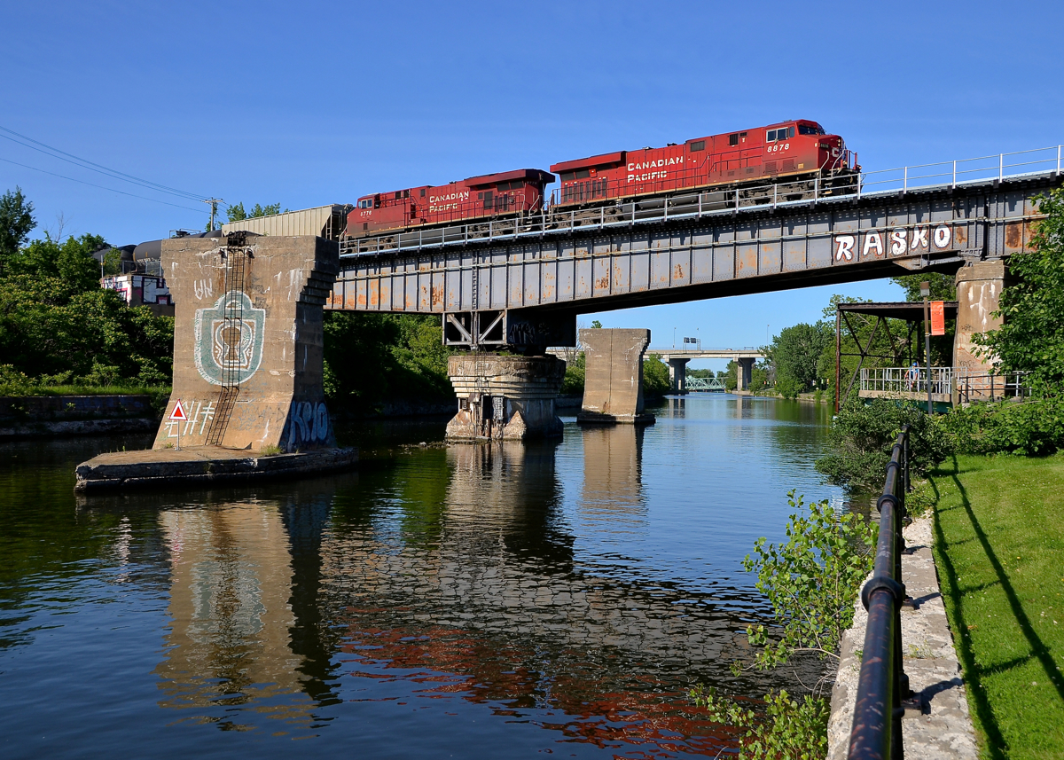 CP 550 over an old swing bridge. A pair of ES44AC's (CP 8878 & CP 8776) lead oil train CP 550 over the Lachine canal with a new crew onboard. This was once a swing bridge over the Lachine canal but is now locked in place.