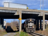 <b>NS running Southern style in Montreal.</b> CN 593, a transfer from Rivière-des-Prairies yard to Taschereau Yard in Montreal is passing underneath highway 40 with NS 7570 running long hood forward, the way that the Southern Railway used to run their diesels (even NS did for awhile). Trailing and out of sight are CN 9416 & CN 7226. This NS unit came into Montreal on CN 529 from Rouses Point, NY.