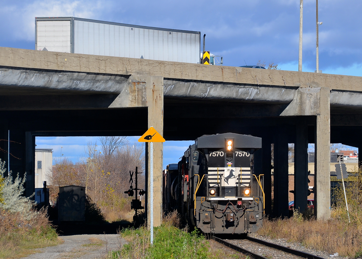 NS running Southern style in Montreal. CN 593, a transfer from Rivière-des-Prairies yard to Taschereau Yard in Montreal is passing underneath highway 40 with NS 7570 running long hood forward, the way that the Southern Railway used to run their diesels (even NS did for awhile). Trailing and out of sight are CN 9416 & CN 7226. This NS unit came into Montreal on CN 529 from Rouses Point, NY.