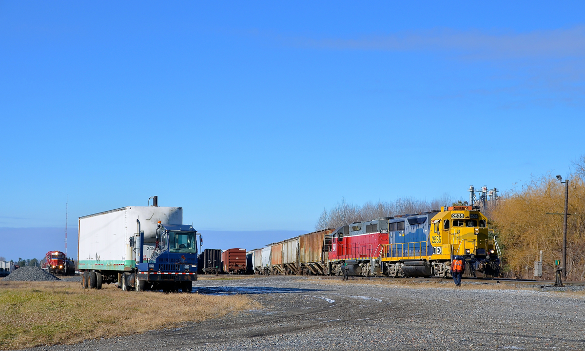 Two CMQ trains ready to leave Farnham Yard. At right CMQ 710 for Newport, VT is starting to pull out of Farnham Yard with LTEX 2535 and CEFX 3803 on a sunny but crisp morning. In the distance at left a yard job is about to leave the yard pull-pull style with CEFX 420 leading and CMQ 2002 at the rear end on its way to a propane facility in Brigham, Qc.