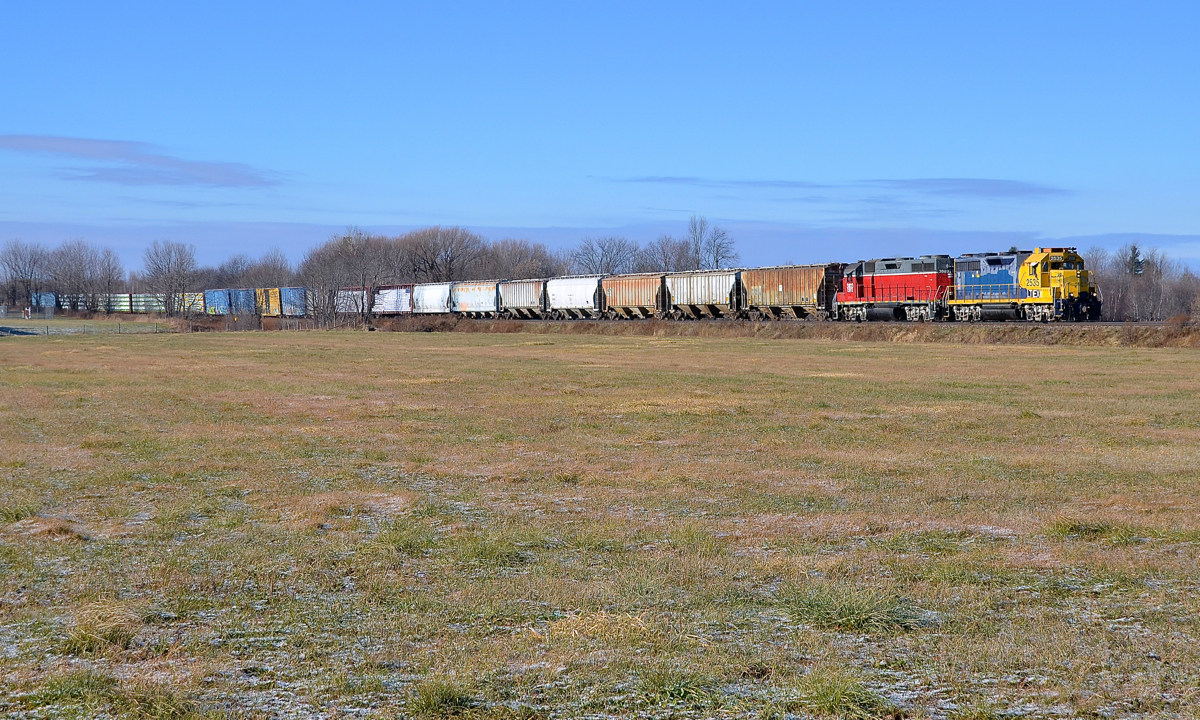 Ex-Santa Fe GP35u leading. CMQ 710 for Newport, VT is about to leave the Sherbrooke Sub for the Newport Sub as it passes through Brookport, junction point for the two subdivisions. Power is ex-Santa Fe GP35u LTEX 2535 and ex-Southern GP38-3 CEFX 3803.