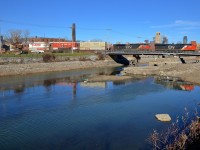 <b>Stack train over the canal.</b> CN 120 has CN 2866 & CN 8946 at the head end and CN 2842 operating mid-train on this nearly 14,000 foot long train, which is bound for Halifax. Here it is crossing the Lachine canal in Montreal.