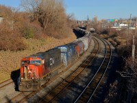 CN 527 heads west with CN 5698 and IC 2460 for power on a sunny afternoon in Montreal West.