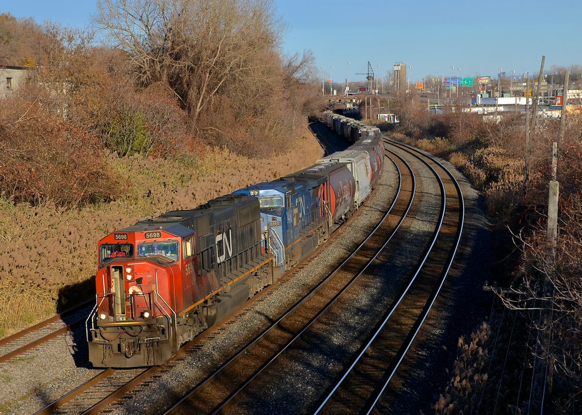 CN 527 heads west with CN 5698 and IC 2460 for power on a sunny afternoon in Montreal West.