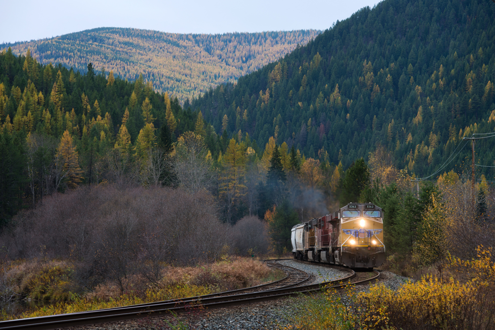 Eastbound grain empties make their way past the siding at Tochty with some run through UP power on the point.