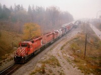 T'was a nice morning for a day off so I thought I would nip up to Goderich and see what was happening on the GEXR. Of course one must always check Woodstock on the way. It is a TIMs stop. On my way back to Hwy 59 and northward, the light went green for an eastbound. Since the area was socked in with fog, I wasn't too concerned about getting a decent shot, but went up on the overpass anyway. Wouldn't you know it? Lousy weather, great lashup. Here, charging thru the mist is CP 5684, 5643, SOO 6003, HLCX 6069, STLH 5542, CP 5503, SOO 6026 and CP 5518. Best train of the day, and it is only 0800!!