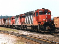 GP40s on CN on the roster as 4002-4017 were renumbered to 9302-9317 in 1981. The CTG shows no 9311. Does anyone know what happened to it? Wrecked as 4011??  Anyway, it was rather unusual to say the least that 4 of these units would unite to power one train. Pictured is CN 9309, 9312, 9305 and 9313 slowing to a stop in Hamilton yard on a run from Mac. Here, one of the units was set off so I did not follow the train down Niagara. The standard GP40s were all off the roster by 1998; the 9309 to RLK then retired; the 9305 to UP and most recent it is wandering as GMTX 2102. The 9312 and 9313 went to Roberval & Saguenay as their #'s 60 and 66.