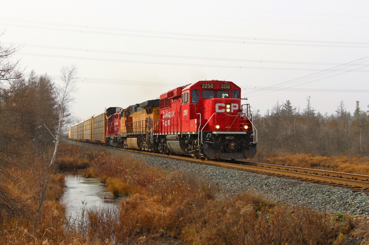 Having cleared from Wolverton and by the rail crew in the Puslinch siding, CP 2250 along with BNSF 4585 and CP 3120, cruises up to Concession 7 on a cold, snowy, overcast afternoon.