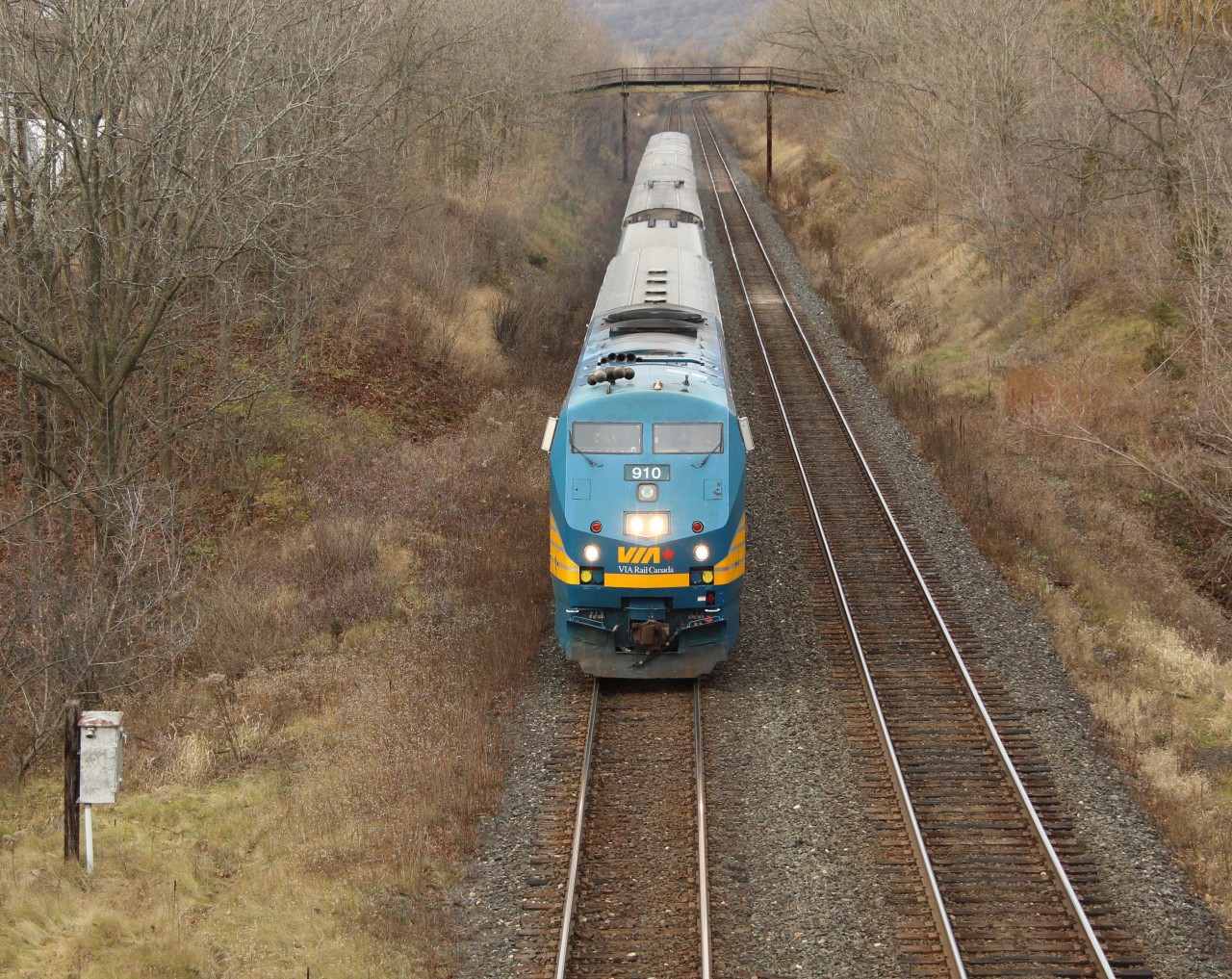 Via Rail 910 coasts down the hill and under the Royal Botanical Gardens walk bridge and up to Old Guelph Road after passing MM 1 of the Dundas sub, awaiting clearance from the work crew at MM 0.6 at Bayview Junction.