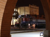 It's hard to make a trip to Kitchener's VIA/GO station without framing something in the building arches. The station and old factory here are very photogenic either day or night. On this night GEXR local 580s power was posing perfectly between the arches with the old Krug furniture factory in the background. 