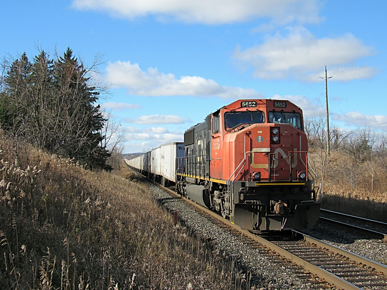 Climbing the dip just east of Georgetown, Ontario, possibly the final CN Q144 roadrailer rushes by on it's way to Mac Yard. A solo SD75I powers this train, which will be missed.