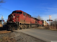 An AC4400CW and an ES44AC are on point of northbound intermodal train 113, with another AC4400CW hiding away mid train, as they pass Kirby Road south of Bolton in Nashville heading north, just departing Vaughan IMS. Northbound oil train #551 was waiting at Elder Station for 113 to exit Vaughan, and 118 was in the siding at Bolton to wait for the 2 to pass before proceeding southward again.