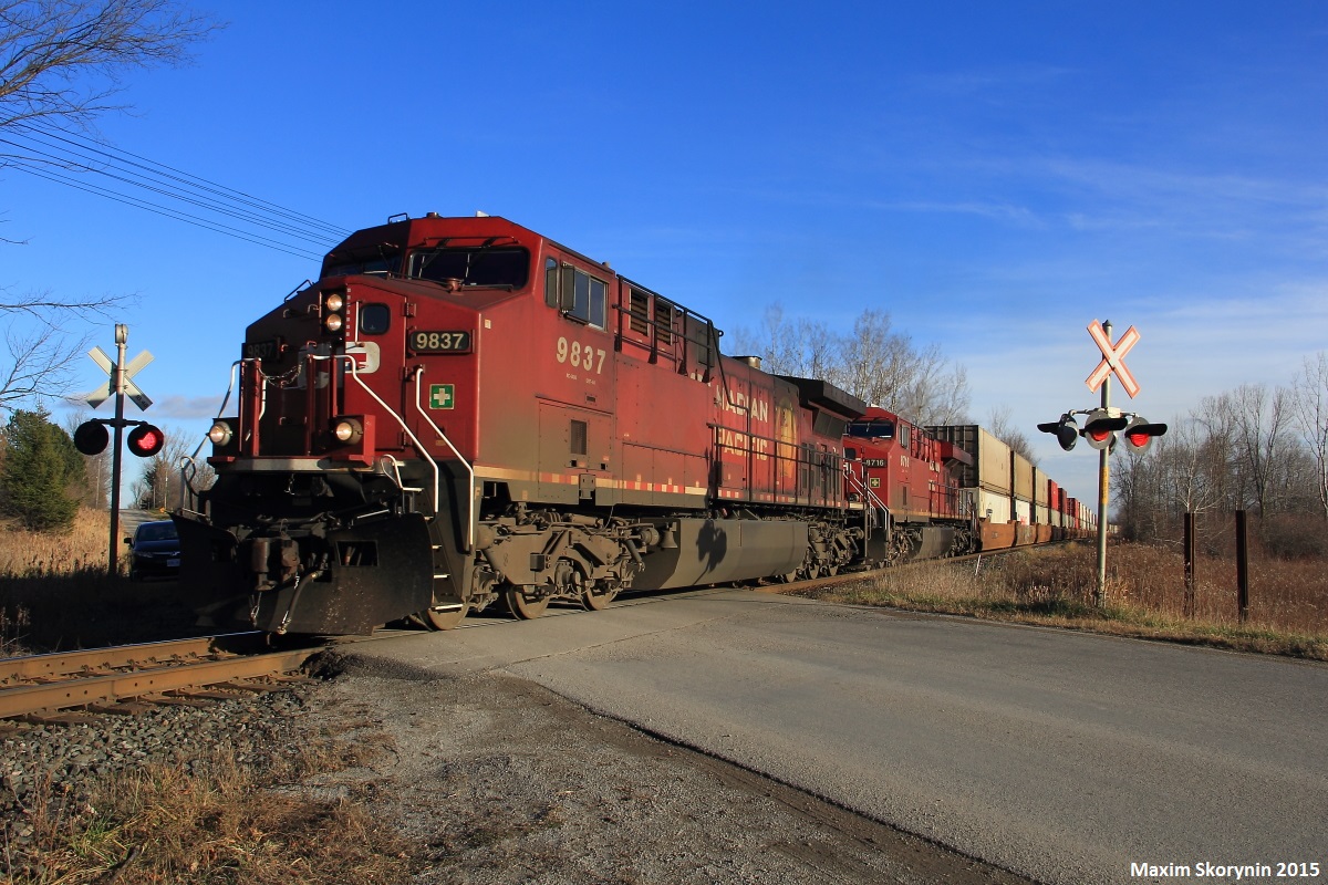 An AC4400CW and an ES44AC are on point of northbound intermodal train 113, with another AC4400CW hiding away mid train, as they pass Kirby Road south of Bolton in Nashville heading north, just departing Vaughan IMS. Northbound oil train #551 was waiting at Elder Station for 113 to exit Vaughan, and 118 was in the siding at Bolton to wait for the 2 to pass before proceeding southward again.