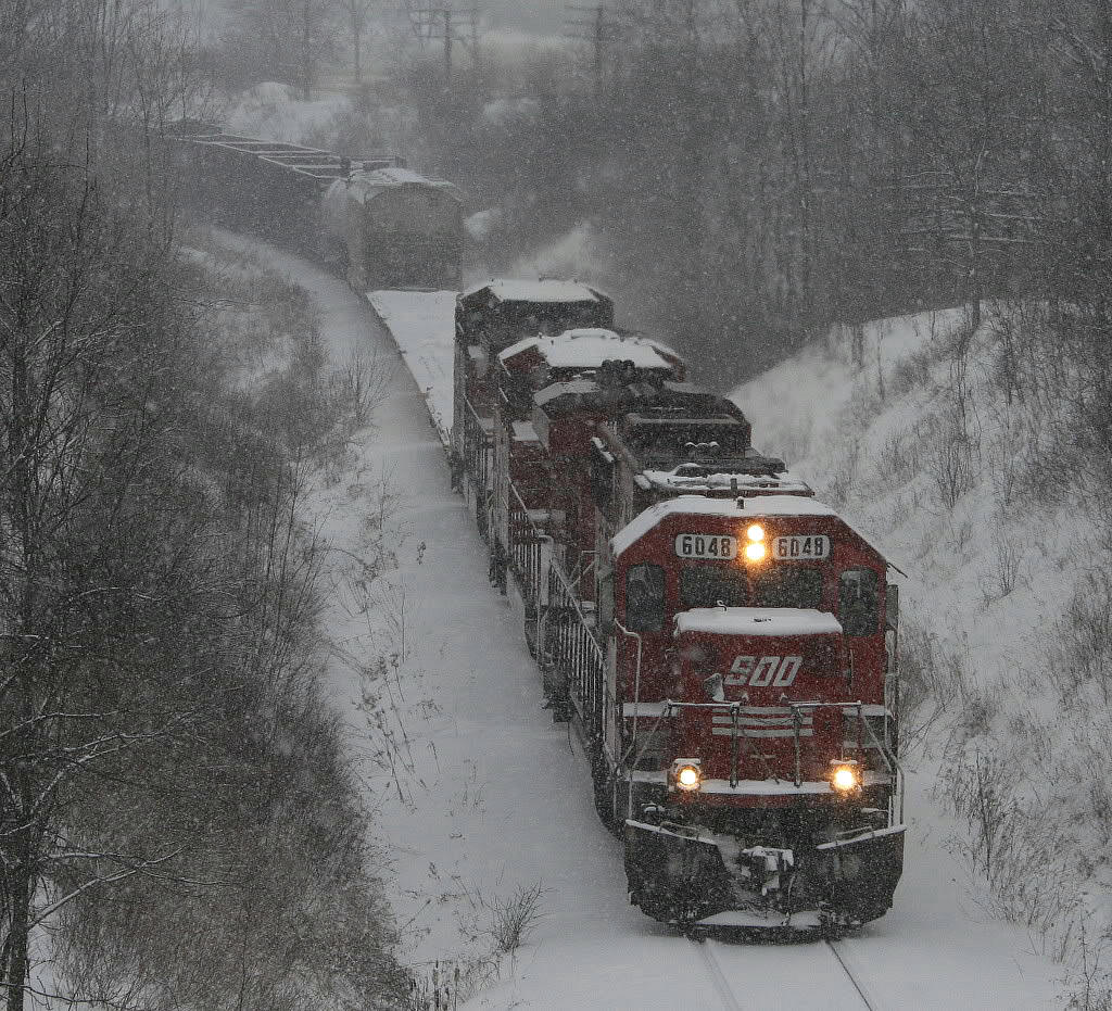 CP 255 climbs the Hamilton Sub during a heavy January snowstorm...a nice red SOO leading...taken from the then new Newman Road overpass looking west