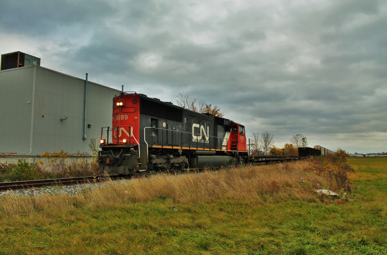 After a wild chase through Windsor I was finally able to get in front of 438 on this grey October afternoon. I was on CP when I heard 438 call in to get clearance to leave Van De Water. I was in front of it along the CASO and I was going to go for a shot of it coming off of the CASO and going onto the Pelton but I took too long trying to find a good spot and the train snuck up on me. I ended up getting stuck by it on Provincial Rd. at Walker. I then decided to follow it along Walker. It wasn't hard getting in front again as I hit all of the green lights on Walker and CN only goes about 10-15mph on the Pelton. I was able to get him at the last crossing along the Pelton Spur which is Foster Ave. and even then I only beat him by about a minute. Train chasing in Windsor can be pretty challenging.