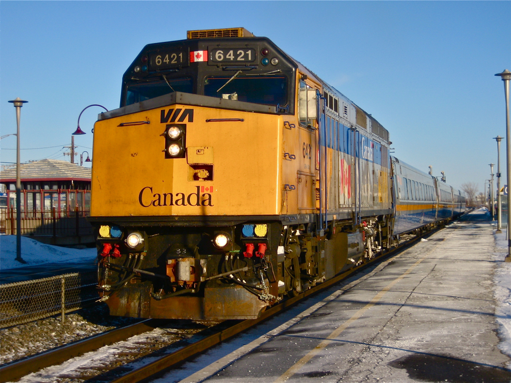 Before being repainted. A couple of years before it was rebuilt and repainted, VIA 6421 is stopped at Dorval station with 4 LRC cars in tow.