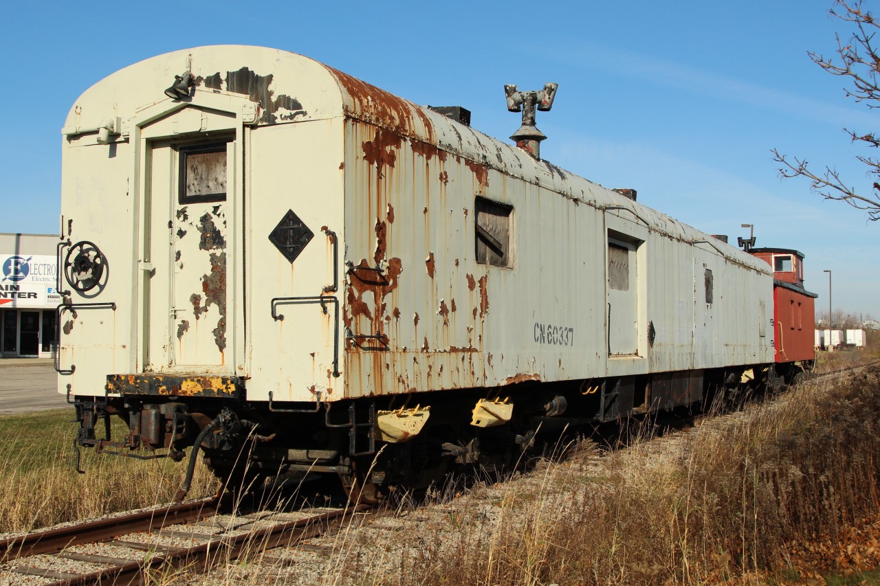 Owned by the Guelph Historical Railway Association, the tattered Ex CN 8990 Baggage car and now CN 60337 tool car which was built in 1950, sits on the siding just before Elmira Rd in Guelph. Behind it sits a very nice caboose with "Please don't vandalize our equipment. Our members will be very sad" posters in the windows, and an invitation to all interested rail fans to join the group.
