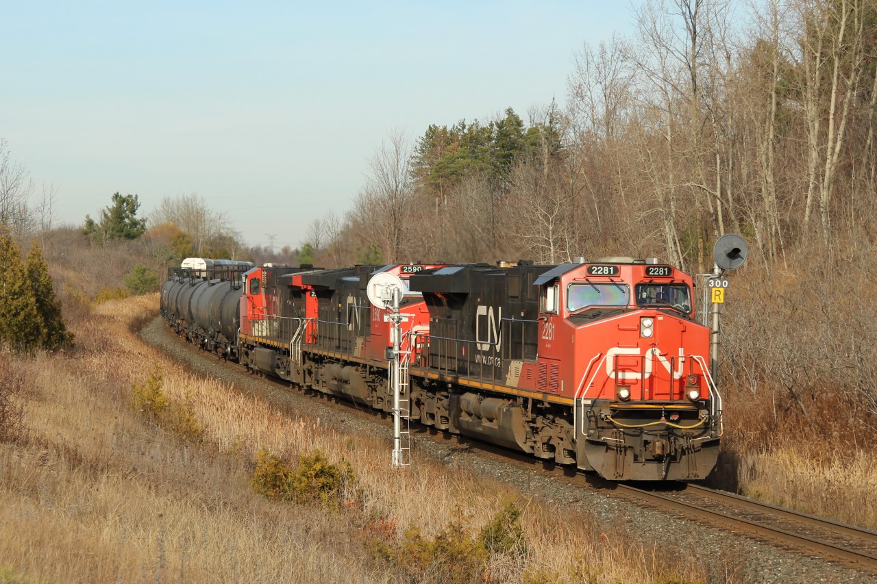 With the fall colours gone and the winter brown invading, CN 2281 leads CN 2590 and CN 2517 through signal 300 and up to MM30 on the Halton sub with a mixed manifest of freight.