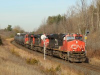 With the fall colours gone and the winter brown invading, CN 2281 leads CN 2590 and CN 2517 through signal 300 and up to MM30 on the Halton sub with a mixed manifest of freight.