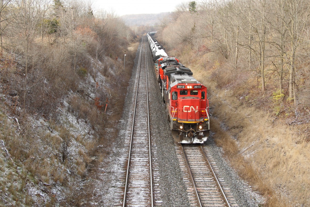 CN 2010 and CN 8956 coast down the hill past MM 1 on the Dundas sub heading for the Oakville sub at Bayview Junction with a snow covered manifest of mixed freight.