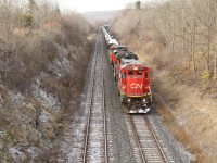 CN 2010 and CN 8956 coast down the hill past MM 1 on the Dundas sub heading for the Oakville sub at Bayview Junction with a snow covered manifest of mixed freight.