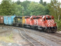 The dullest days bring out the best trains. I had been hanging around Parry Sound station again, hoping to catch something in the "interesting leasers" department, as around this time CP was grabbing any locomotive they could get their hands on. Or so it seemed. I knew there were a handful of Kennecott Copper units roaming around, and couldn't believe my luck actually catching one. And standing on the rocks opposite the station was the best place to be, seeing the unit was third in the consist. Too bad for a very dull windy dark day, it made getting a good sharp image rather difficult. But this shot of CP 5591, 5521 and KCC 106 coming off the big Parry Sound trestle was certainly better than nothing.