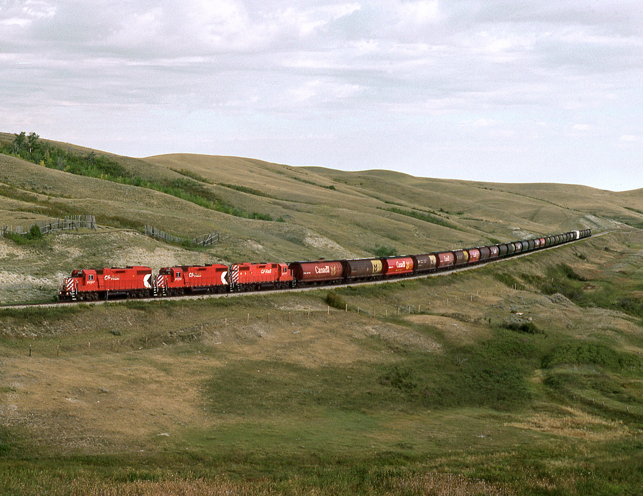 Southbound Fife Lake Subdivision grain spotter bound for Coronach Sask. climbs out of a coulee just to the north of Scout Lake