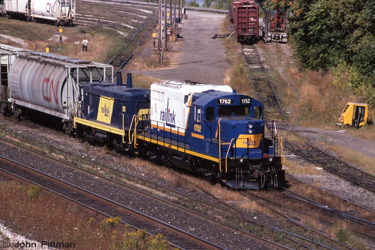 GP9u RLK 1752 and cabless switcher 1200, both in clean paint, are switching cars in Stuart Street Yard, Hamilton ON.