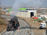 <b>What is this and where?</b> this is the Waterloo Central Railway, operating a steam special on Remembrance day to transport Veterans to a ceremony in downtown Waterloo. One time permission was granted for this move, the train dodging oodles of crews busily finishing the right of way work on the Waterloo "ION" LRT. This track was and still is the GEXR Waterloo spur, but it's quickly taking shape as something completely different. In the background, the ION maintenance facility, soon to be filled with more tracks and blue Bombardier Flexity trainsets, you'll hardly recognize this place come the Spring.. it's already quite different than what it once was.<br><br>
Interestingly enough, just around the curve there was the site of the most notorious train wreck on this line on September 7 1902. (Source: Rambles of the Dutch Mail, George Roth, August 2011)




