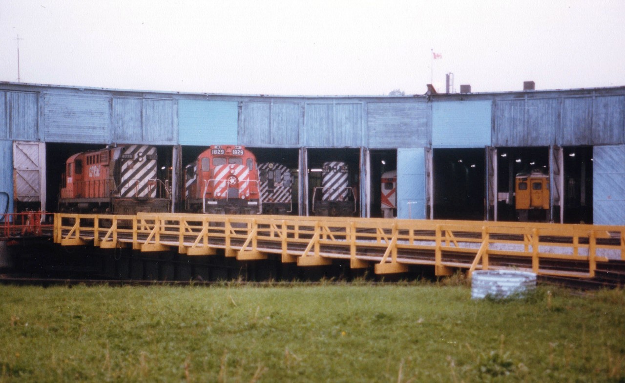 I have forgotten just exactly where the Sudbury roundhouse stood. All I can recall is it wasn't far from the Doran's Brewery:o)  Went back up that way some years back and the roundhouse was gone. Someone on the list will pinpoint its' location, I am sure of that. This view taken 30 years ago as of this posting shows it a rather busy place. Assortment of CP power as well as a couple of Budds inside. Somehow in the back of my mind I think I heard the building was destroyed by fire. Anyone? When??  Thanks in advance, as always...............