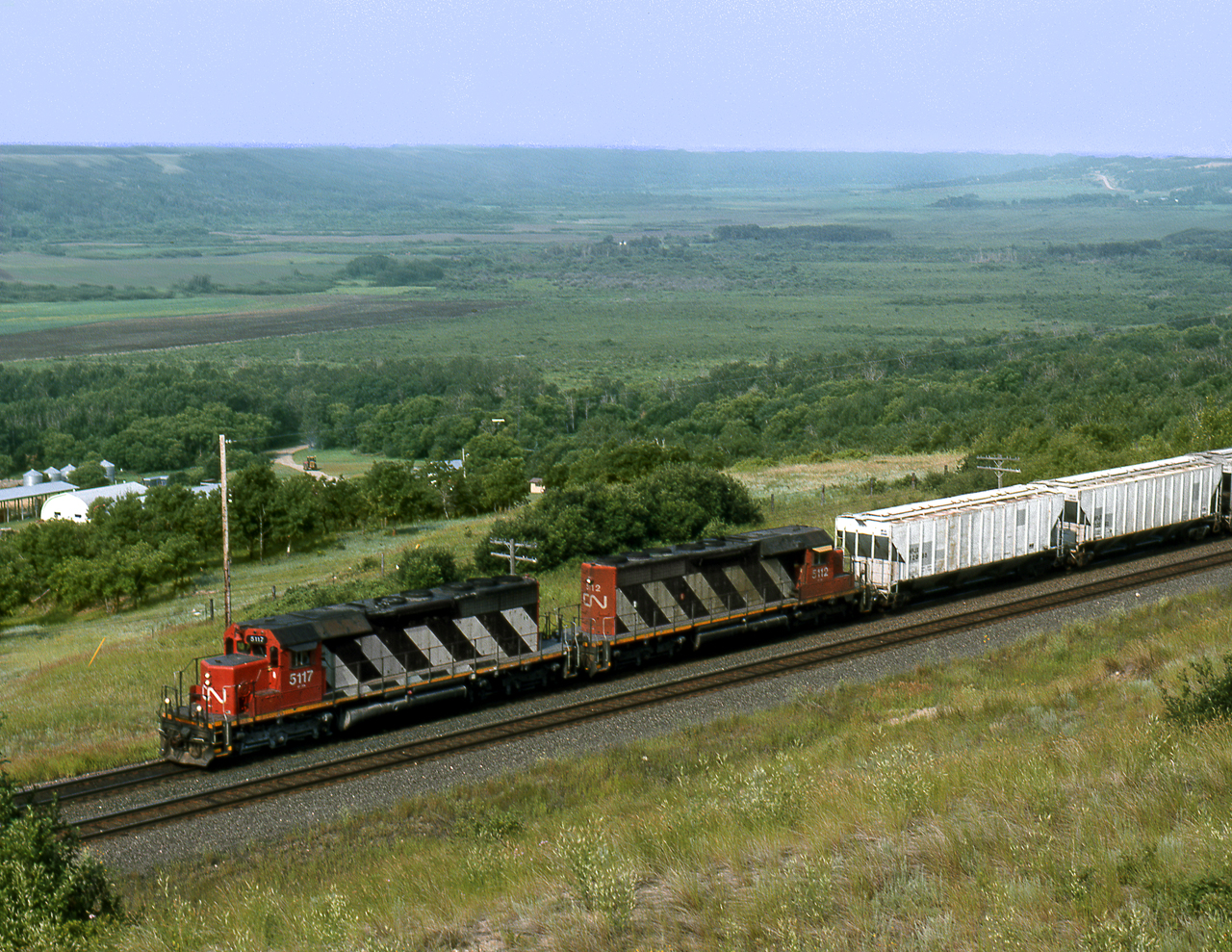 CN potash switcher out of Melville crosses the Saskatchewan/Manitoba border as it drops into the Qu'appelle valley. The train will switch the Rocanville potash mine located on a spur on the other side of the valley