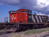 Six axle GMD-1 CN 1614 is at rest outside Symington Diesel Shop, wearing CN class GR-612a.My source indicates CN 1614 was a 1988 rebuild of GMD-1 CN 1046, becoming  the highest numbered 1600. <br>CN 1600's were rebuilt 6 axle (A1A-A1A) GMD-1's.  CN 1400's are rebuilt 4 axle (B-B) GMD-1's. <br><br>In 1998, CN 1614 was converted to B-B trucks and became CN 1444, class GR-412b. I guess lower axle load GMD-1's for lightweight rail branch lines were no longer required. <br><br> Oddball numbered CN SW1200RS CS-02 is to the right, painted black  overall. Canadian Trackside Guide helps explain units CS-01, CS-02,  CS-03, and CS-04. This is the first CS-02, originally CN 1272. CS-02  was a car shop switcher based in Edmonton. First CS-02 and first CS-03  were retired in 1999. <br><br> The second CS-02 was formerly CN 1379; that CS-02 was  withdrawn in 2003. An image of that one awaiting its fate -  http://www.railpictures.ca/?attachment_id=19572