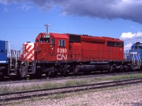 CN 5390, an Ontario Hydro owned SD40-2 formerly assigned to CP Rail, is one of 11 passed to CN along with O.H.'s coal hauling business. My source indicates CN 5390 was formerly CP 5781. Traces of a multimark can be seen around the radiator intake grilles. <br>It is resting outside the Symington Yard Diesel Shop in eastern Winnipeg, sandwiched between Conrail units CR 6662 and CR 6453. It could be used on any train systemwide. CP re-acquired 10 of them in year 2000. <br><br>For a while after privatization, it was sometimes still possible to obtain permission to visit CN facilities and take photographs. Sincere thanks to the people who authorized me, I hope there were no downsides for you. 